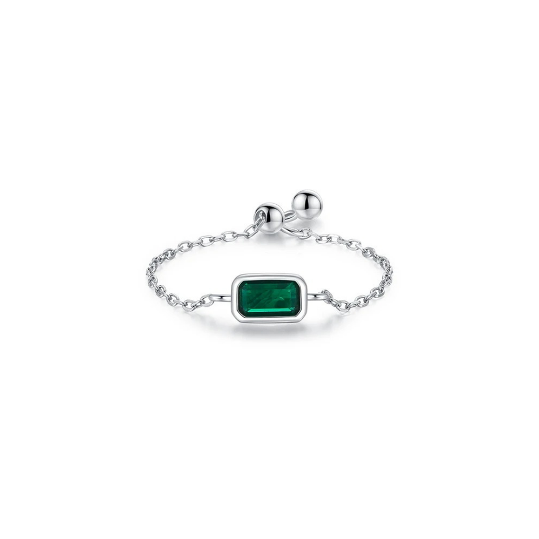 Silver bracelet with a green gemstone on a white background