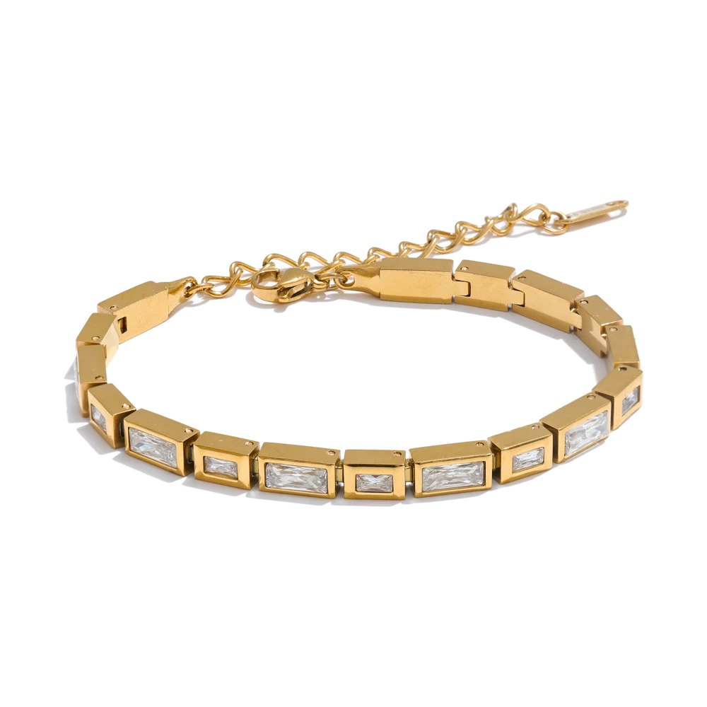 Gold bracelet with square gemstones on a white background