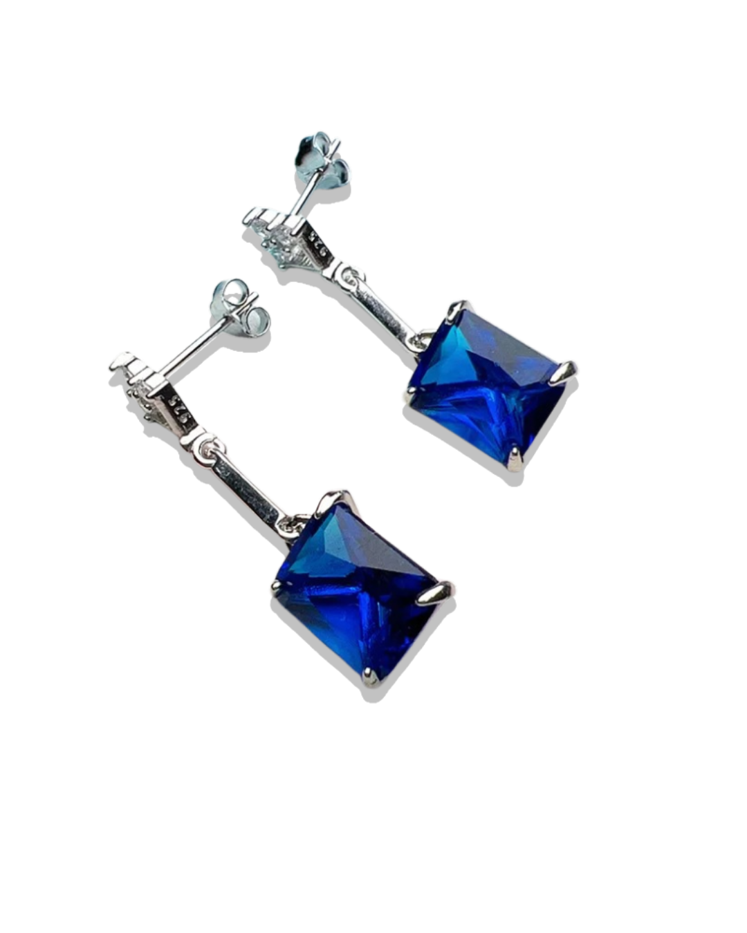 Pair of silver earrings with blue gemstones on a white background
