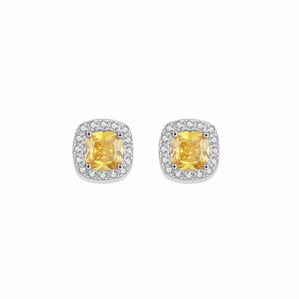 Pair of yellow gemstone earrings with silver frames on a white background